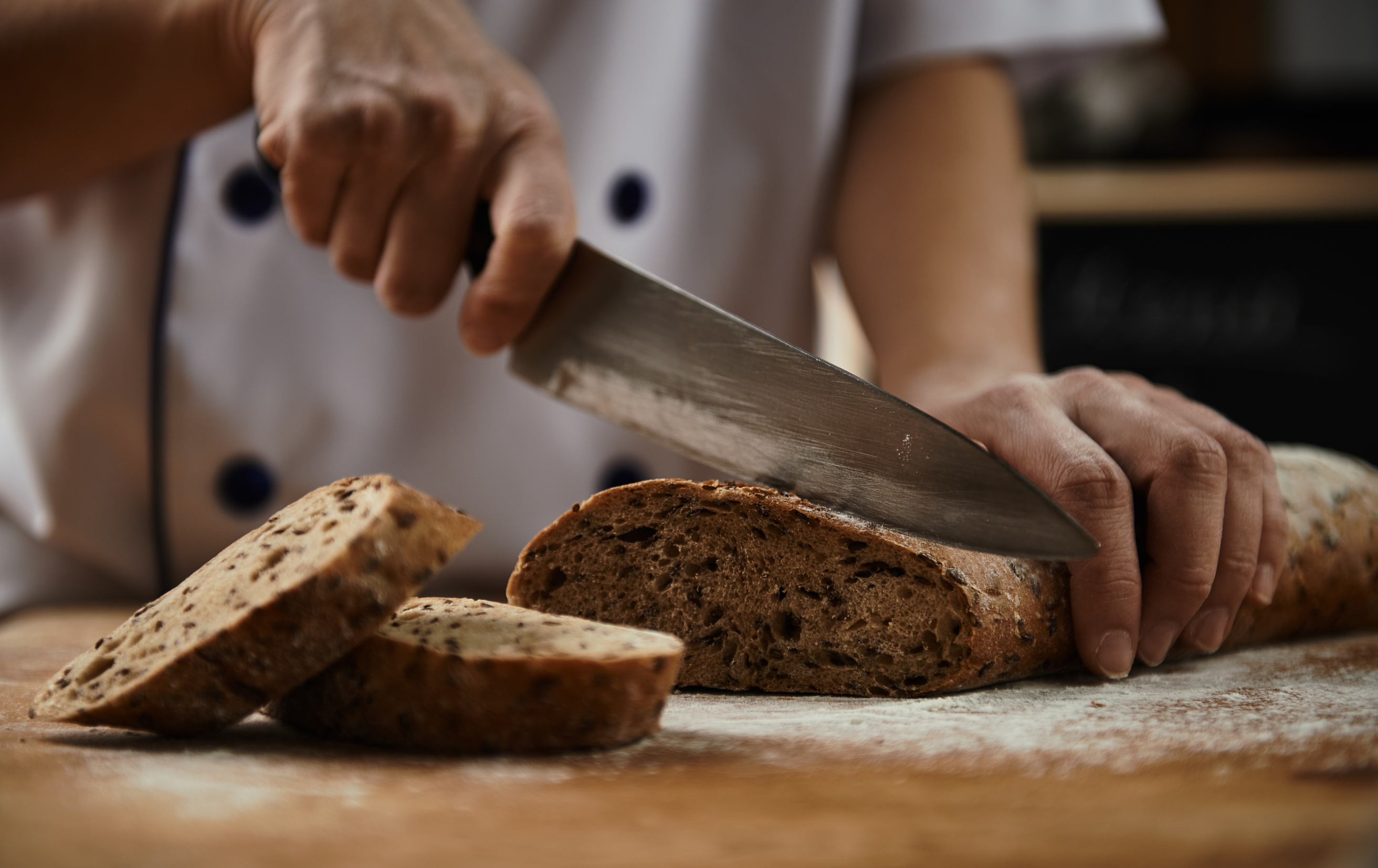 Baker cutting bread